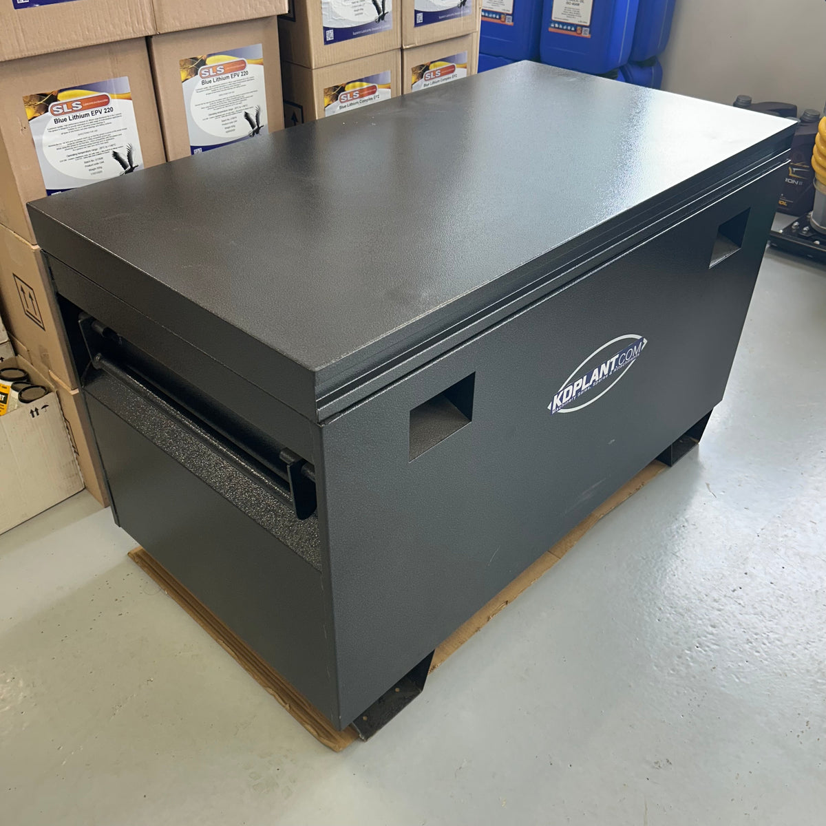 Gray storage box with a brand logo on a warehouse floor