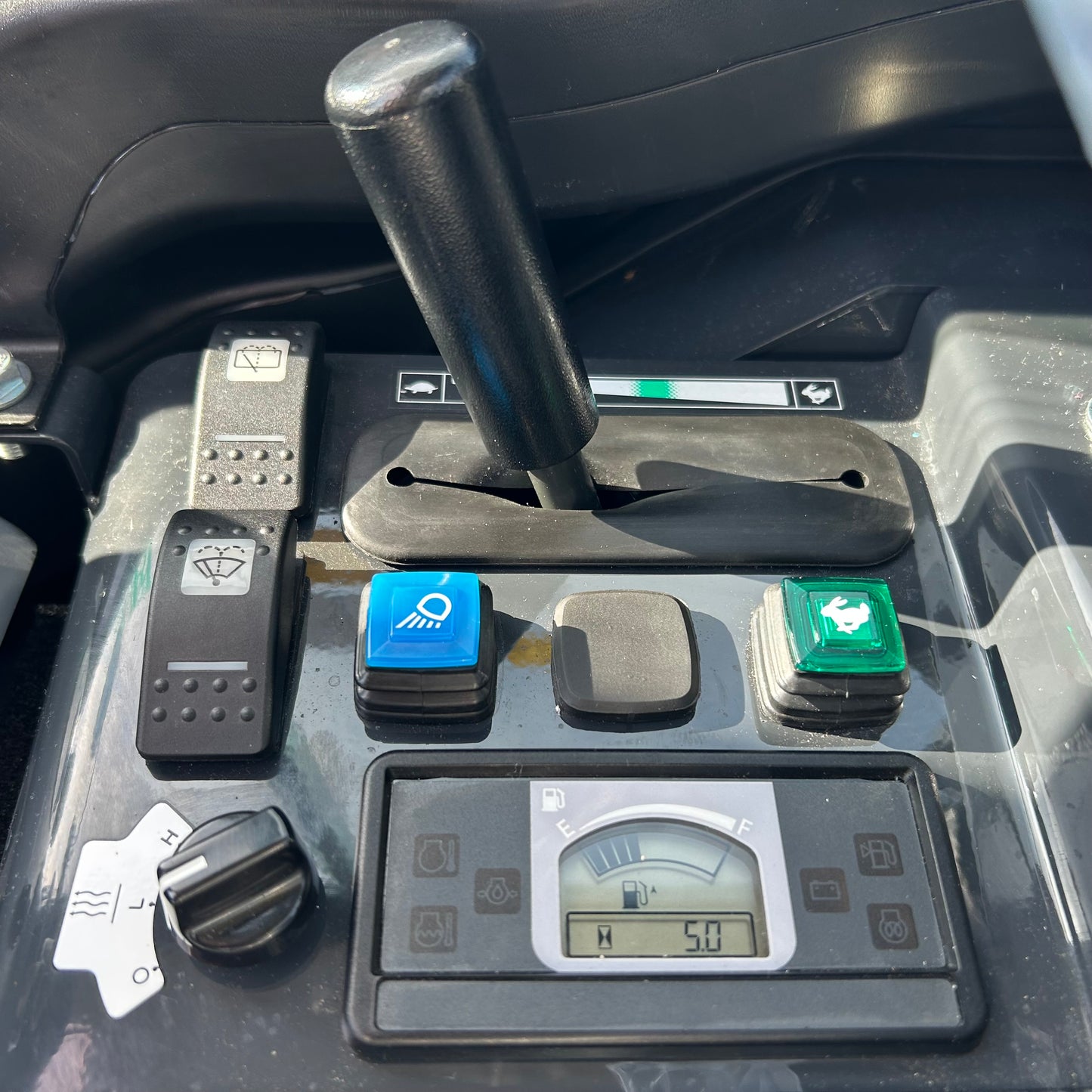 Control panel with buttons and a digital display in a vehicle
