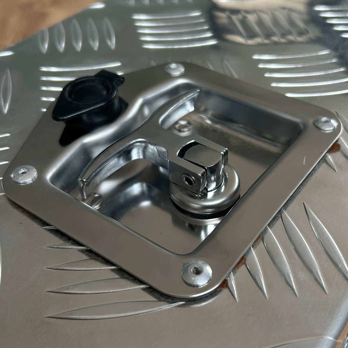 Metallic surface with a textured pattern and a central component